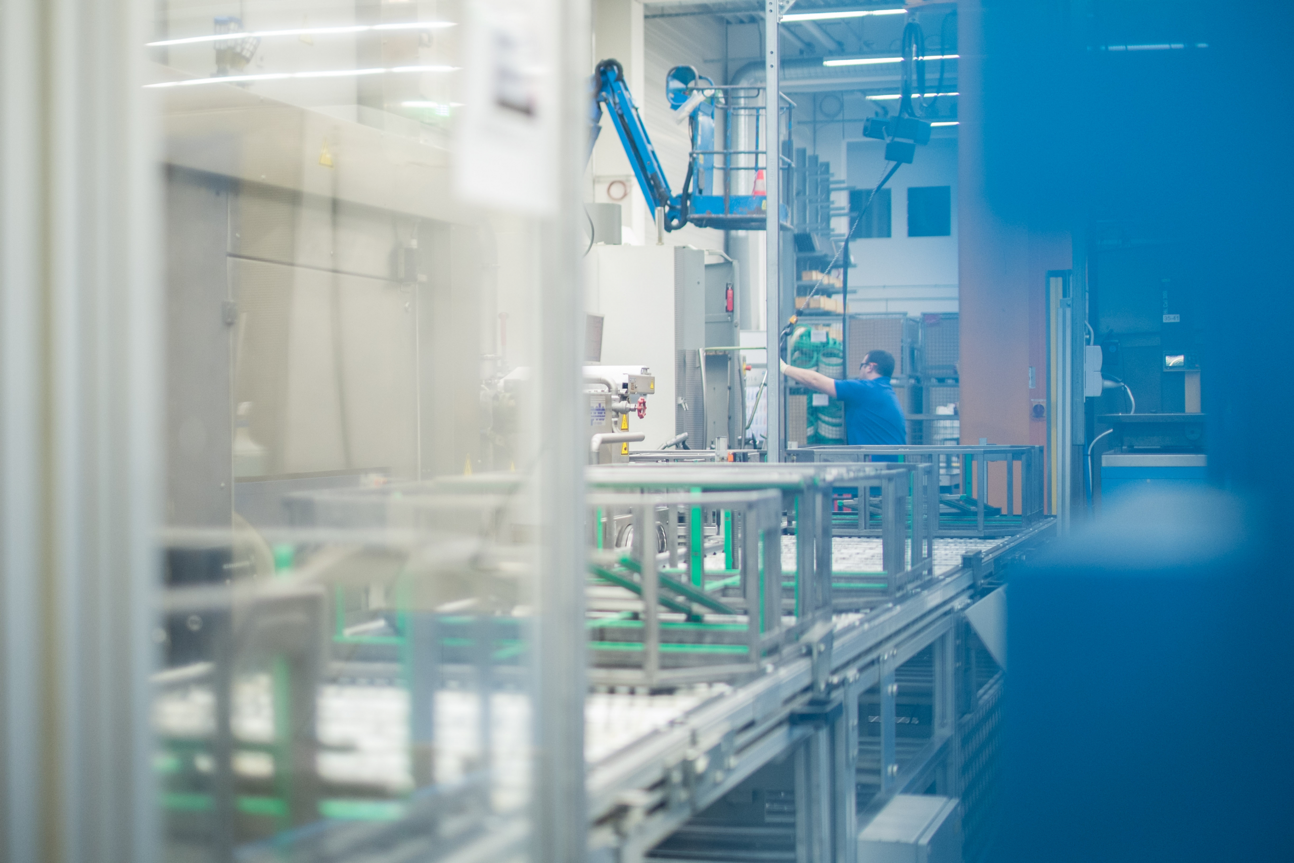 Worker operating tools on a manufacturing assembly line