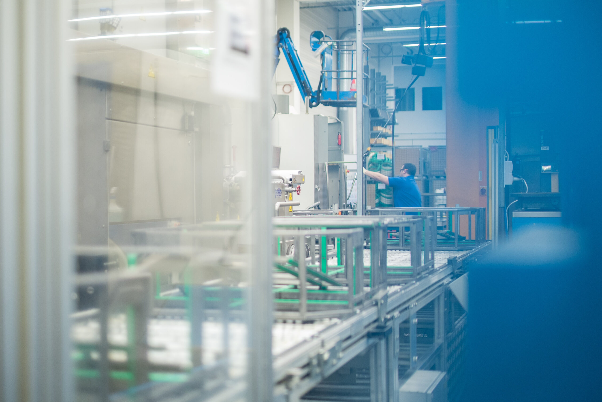 Worker operating tools on a manufacturing assembly line