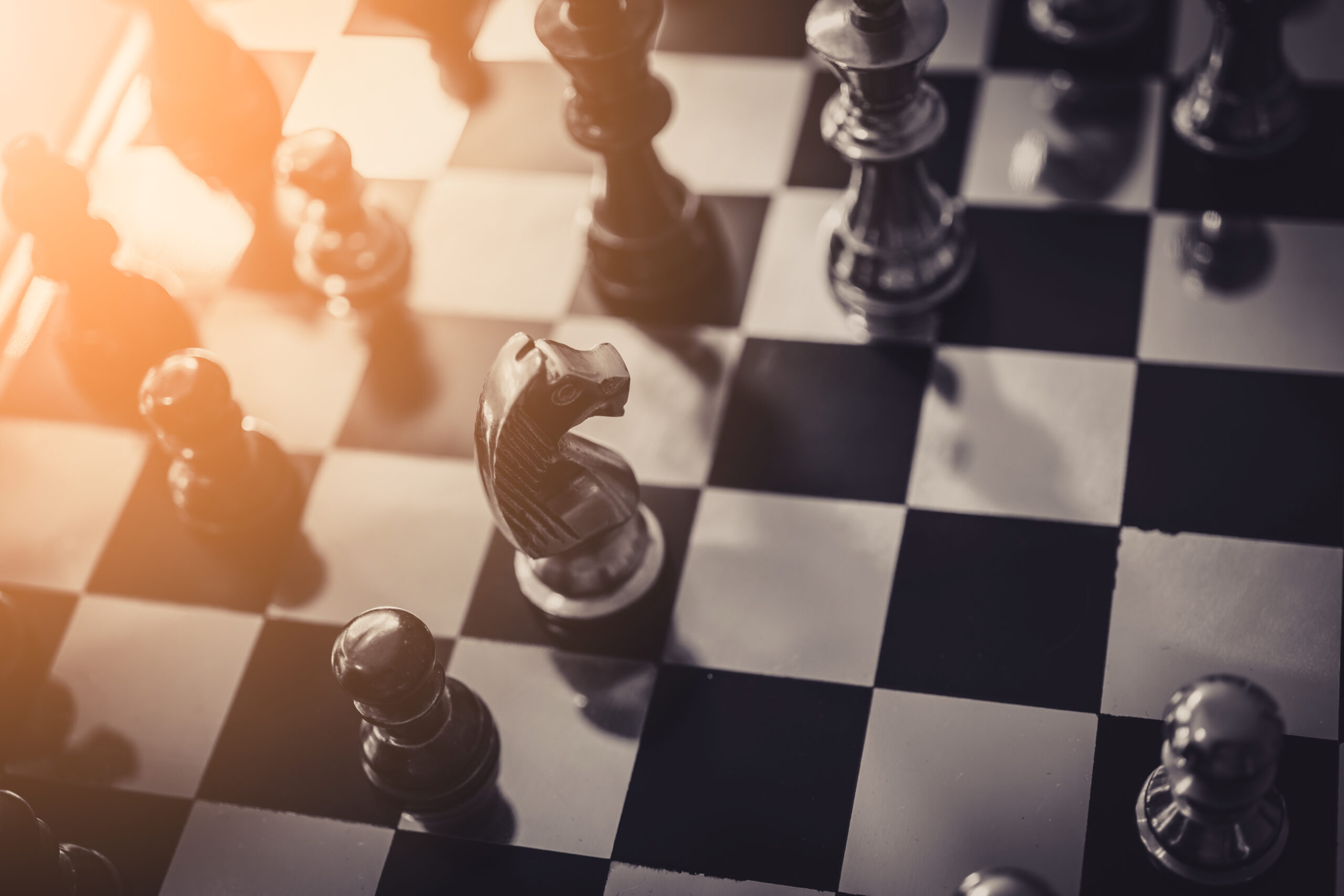 business strategy brainstorm chess board game with hand touch black background with free copy space for your text So treffen Sie die richtigen Vergabe-Entscheidungen
