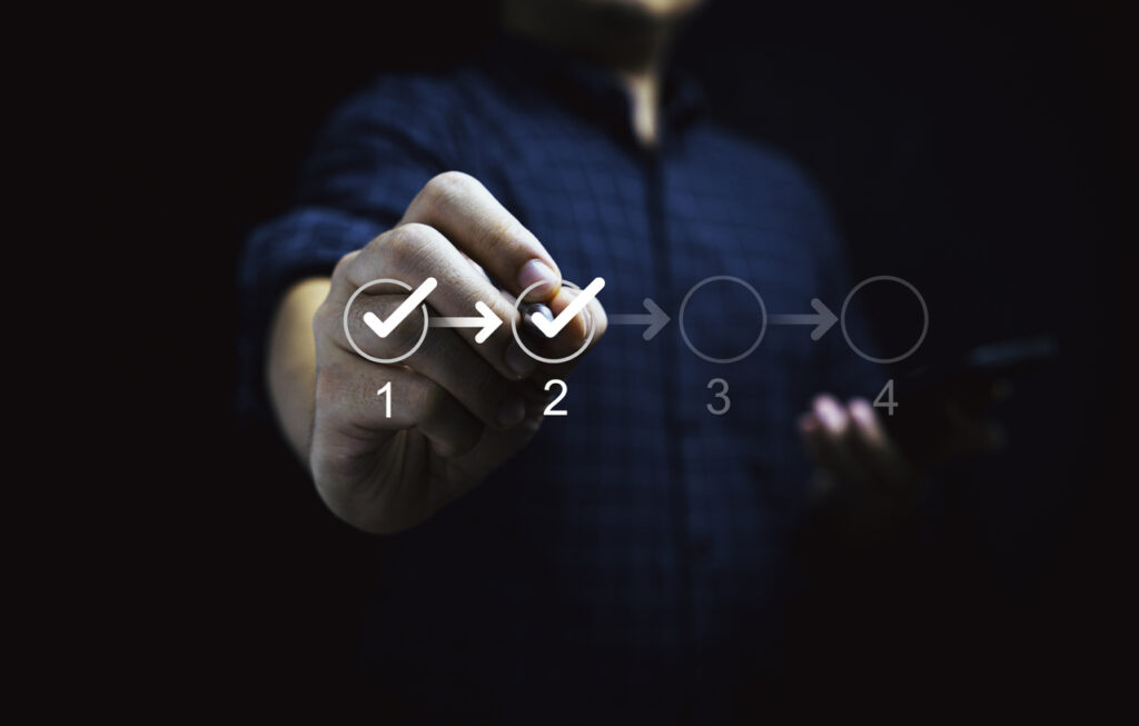 Procurement Manager touching to tick correct mark in checklist